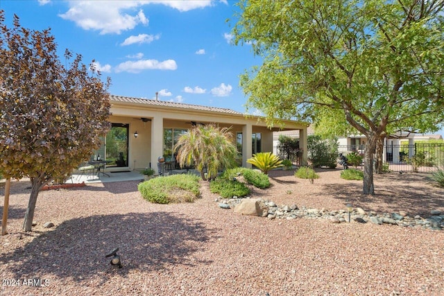 back of property with a patio