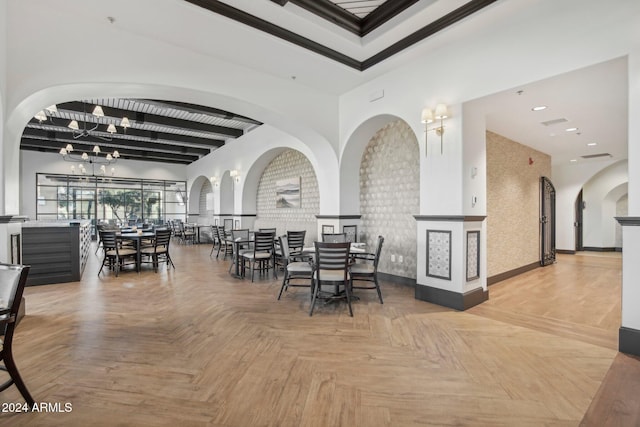 dining room with parquet flooring and a notable chandelier