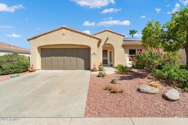 mediterranean / spanish-style house with a garage