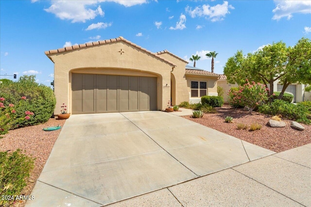 mediterranean / spanish house with a garage