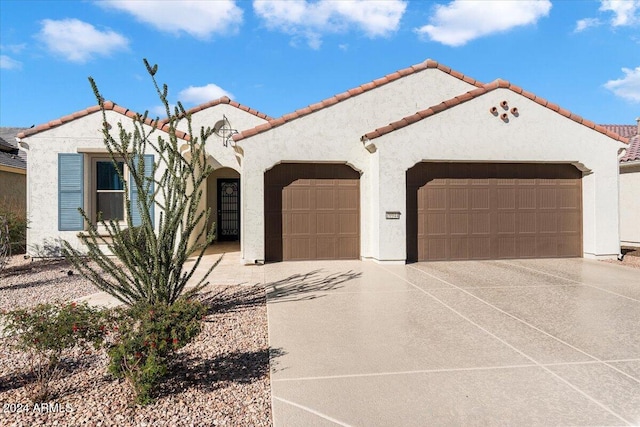 mediterranean / spanish-style house with a garage