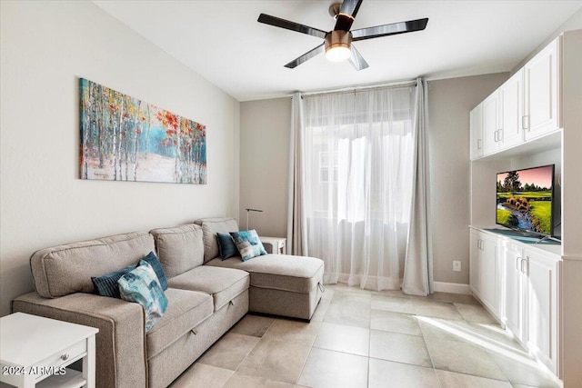 tiled living room featuring ceiling fan