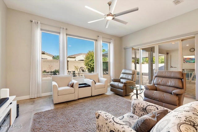 living room with ceiling fan and light tile patterned flooring