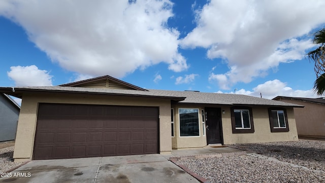 ranch-style home featuring stucco siding, concrete driveway, an attached garage, and a shingled roof