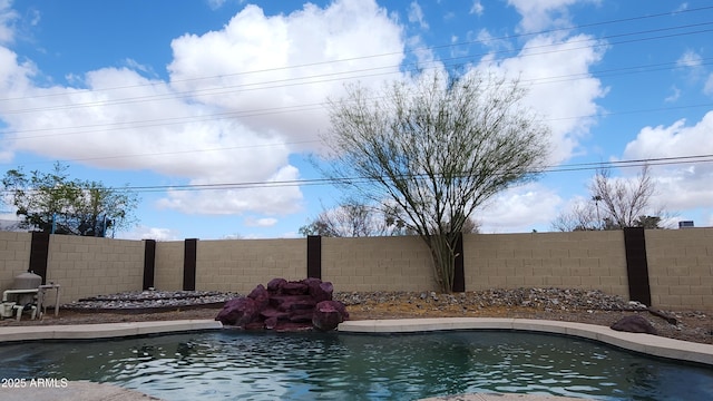 view of swimming pool with a fenced backyard and a fenced in pool