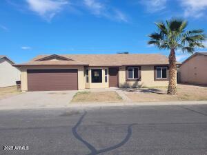 single story home with a garage, driveway, and stucco siding