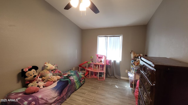 rec room with vaulted ceiling, a ceiling fan, and wood tiled floor