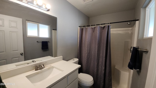 bathroom with vanity, a shower with shower curtain, toilet, and a textured ceiling