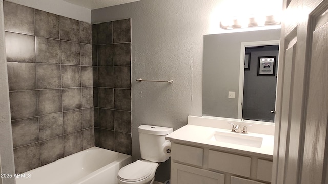 bathroom with vanity, toilet, a textured wall, and shower / bath combination