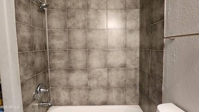 interior details featuring toilet and bathing tub / shower combination