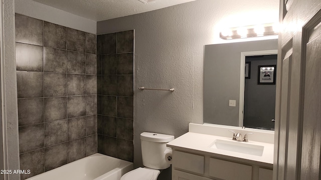 bathroom featuring vanity, a textured ceiling, shower / bath combination, toilet, and a textured wall