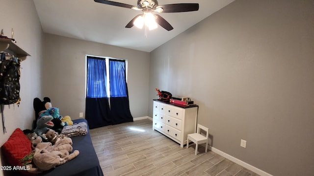 bedroom with baseboards, ceiling fan, and wood tiled floor