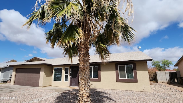 ranch-style home featuring stucco siding, concrete driveway, and an attached garage