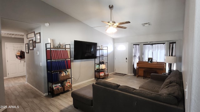 living area with wood finished floors, baseboards, visible vents, ceiling fan, and vaulted ceiling