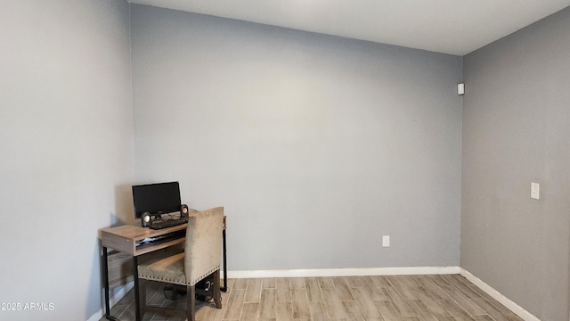 office space with baseboards and wood finished floors