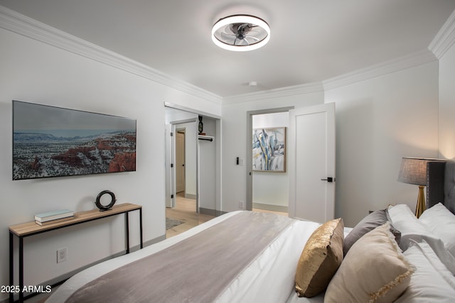 bedroom with crown molding, a closet, and light hardwood / wood-style floors