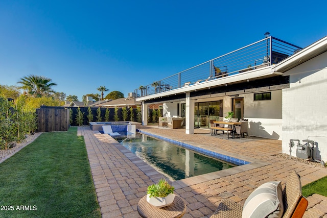 view of swimming pool with outdoor lounge area, an in ground hot tub, a patio, and pool water feature