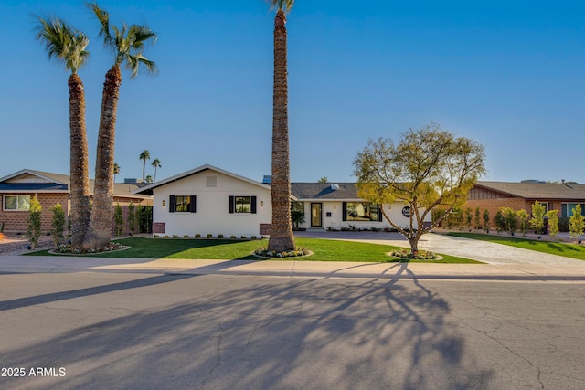 ranch-style home featuring a front yard