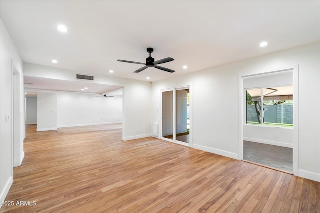 empty room featuring light wood-type flooring and ceiling fan