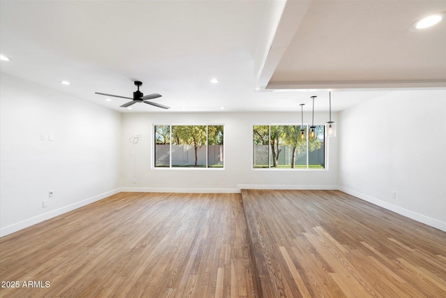 spare room featuring ceiling fan and light hardwood / wood-style floors