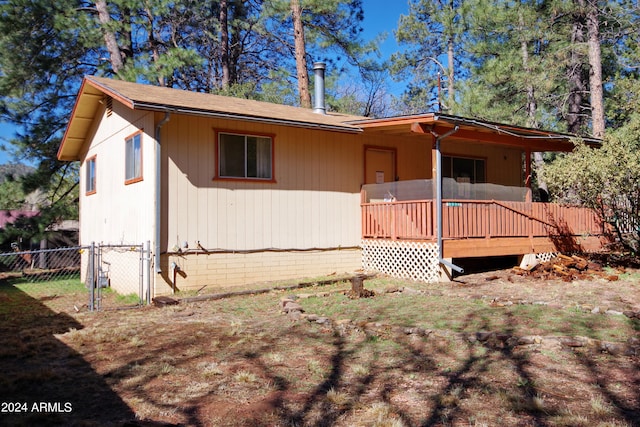 back of property featuring a wooden deck