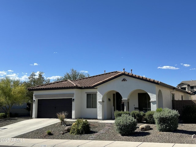 12798 W Dove Wing Way, Peoria, AZ 85383 - mediterranean / spanish house featuring a garage, stucco siding, a tile roof, and concrete driveway