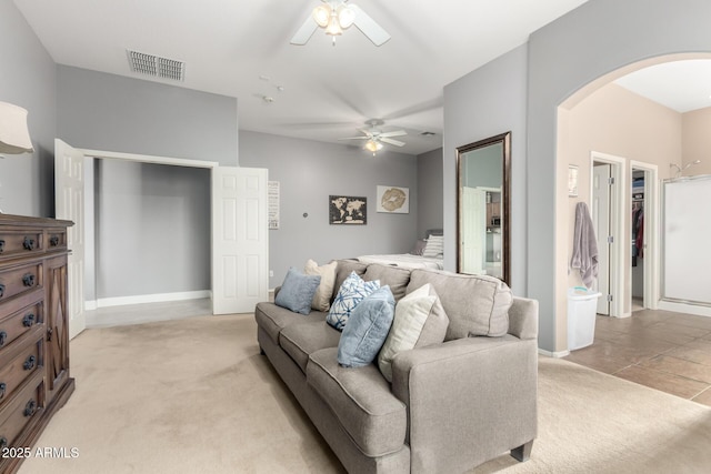 12798 W Dove Wing Way, Peoria, AZ 85383 - living area with arched walkways, light carpet, ceiling fan, and baseboards
