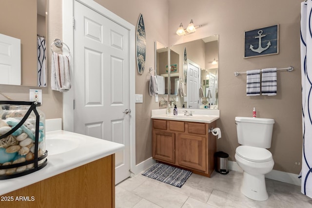 12798 W Dove Wing Way, Peoria, AZ 85383 - bathroom featuring two vanities, toilet, tile patterned flooring, and baseboards