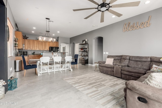 12798 W Dove Wing Way, Peoria, AZ 85383 - living area featuring arched walkways, ceiling fan, recessed lighting, baseboards, and a chandelier