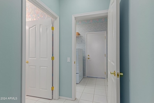 hallway featuring light tile patterned floors and washer / dryer