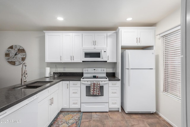 kitchen with sink, white cabinets, and white appliances