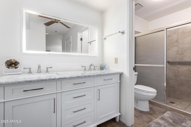 bathroom featuring tile patterned flooring, vanity, ceiling fan, toilet, and a shower with door