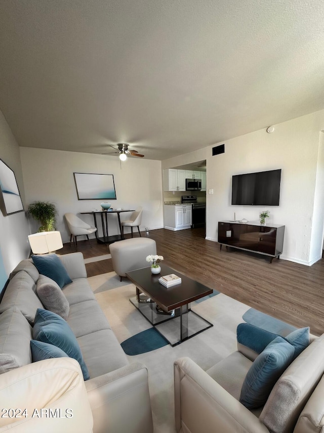 living room featuring ceiling fan and light hardwood / wood-style floors