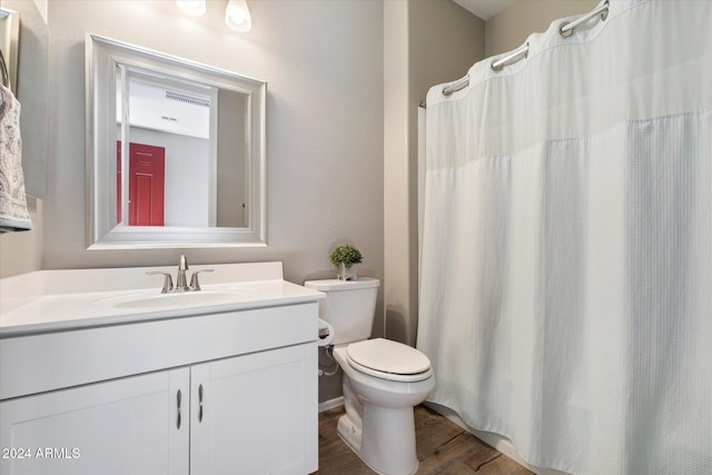 bathroom featuring vanity, hardwood / wood-style flooring, and toilet