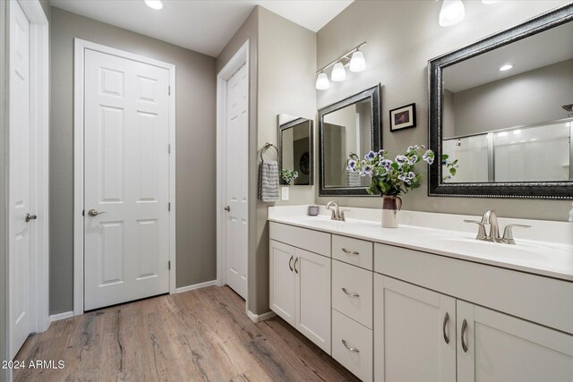 bathroom featuring vanity, hardwood / wood-style flooring, and walk in shower