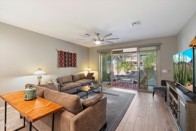 living room with ceiling fan and light hardwood / wood-style flooring