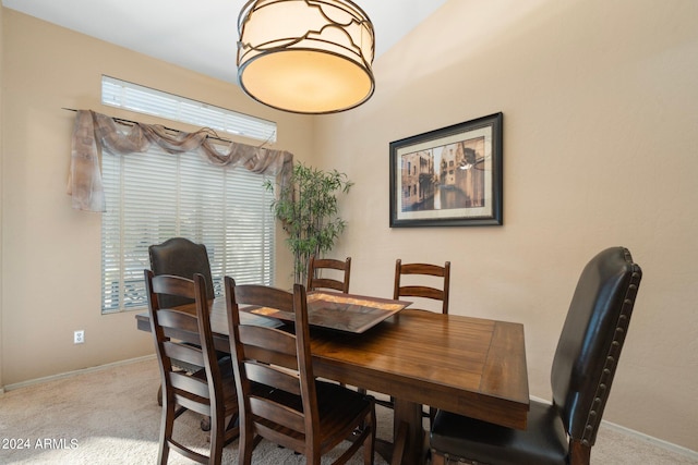 dining area featuring light colored carpet