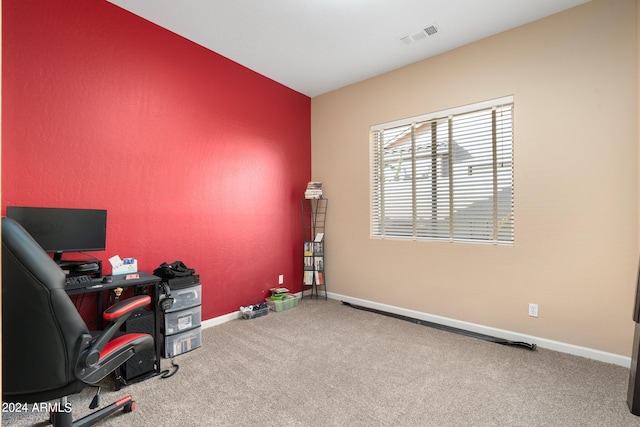 carpeted office space with visible vents and baseboards