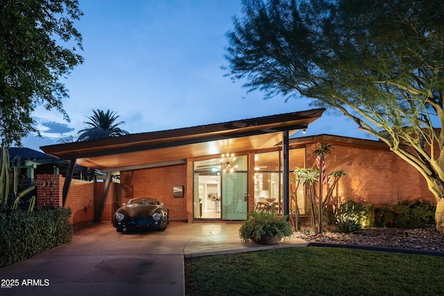 712 W Vernon Ave, Phoenix, AZ 85007 - view of front of house with a carport, brick siding, and driveway