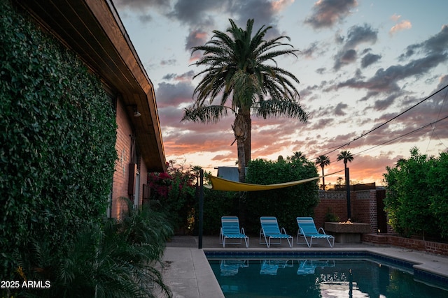 712 W Vernon Ave, Phoenix, AZ 85007 - pool at dusk featuring a patio area, an outdoor pool, and a fenced backyard