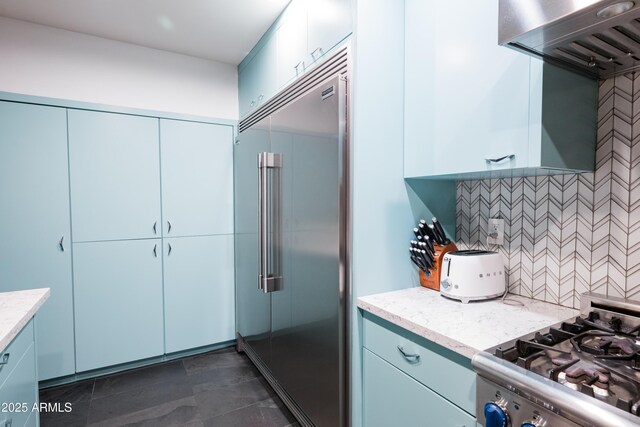 712 W Vernon Ave, Phoenix, AZ 85007 - kitchen with stainless steel built in fridge, range with gas cooktop, ventilation hood, tasteful backsplash, and light stone counters