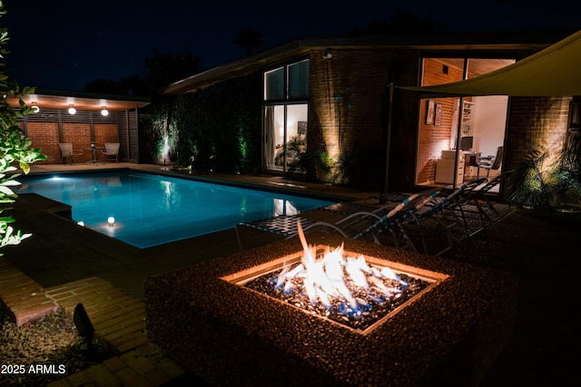 712 W Vernon Ave, Phoenix, AZ 85007 - pool at twilight featuring a fire pit, a patio, and an outdoor pool