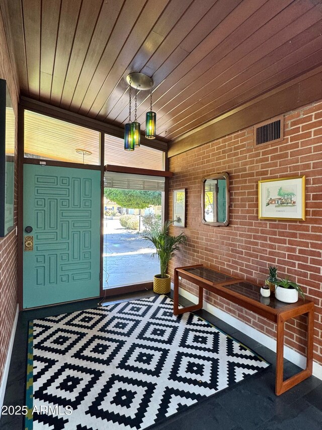 712 W Vernon Ave, Phoenix, AZ 85007 - entrance foyer with brick wall, wood ceiling, carpet flooring, and visible vents