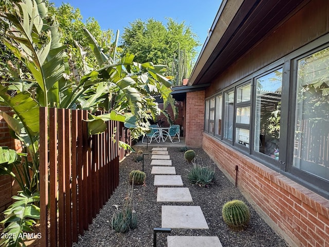 712 W Vernon Ave, Phoenix, AZ 85007 - view of property exterior featuring a patio area, fence, and brick siding