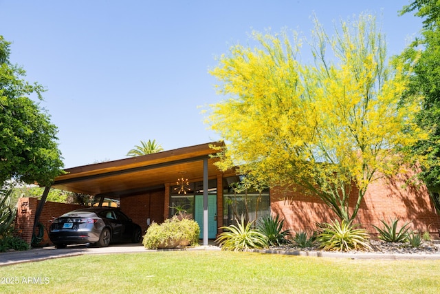 712 W Vernon Ave, Phoenix, AZ 85007 - view of front of property featuring brick siding, driveway, a front yard, and an attached carport