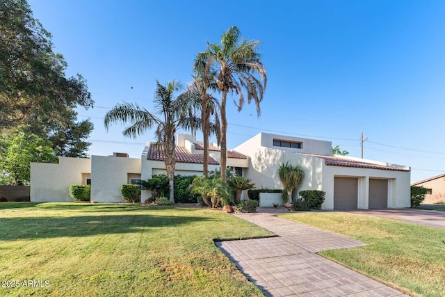 4392 W Charro Ln, Yuma, AZ 85365 - view of front of property with stucco siding, a garage, a front yard, concrete driveway, and a tile roof