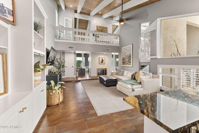 4392 W Charro Ln, Yuma, AZ 85365 - living room featuring beamed ceiling, wooden ceiling, a ceiling fan, and a towering ceiling