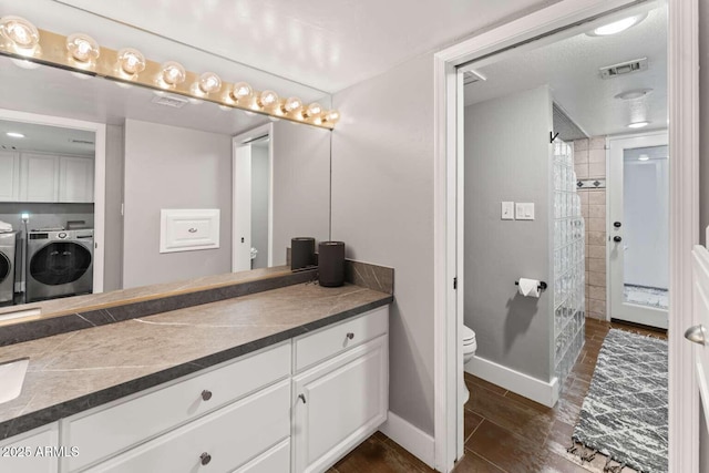 4392 W Charro Ln, Yuma, AZ 85365 - full bath featuring washer and dryer, tiled shower, toilet, and wood finished floors