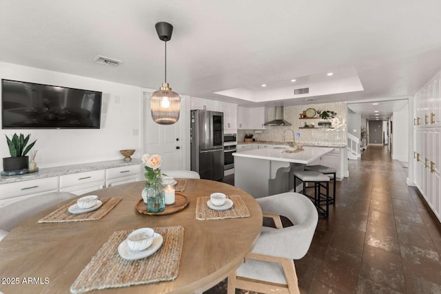4392 W Charro Ln, Yuma, AZ 85365 - dining space with a tray ceiling, recessed lighting, and dark tile patterned flooring