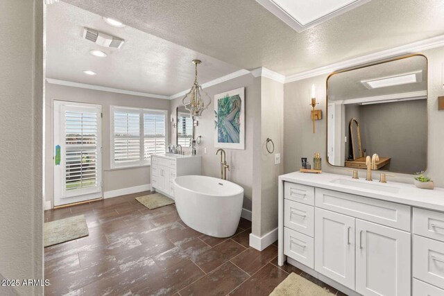 4392 W Charro Ln, Yuma, AZ 85365 - full bathroom featuring crown molding, baseboards, vanity, a textured ceiling, and a soaking tub